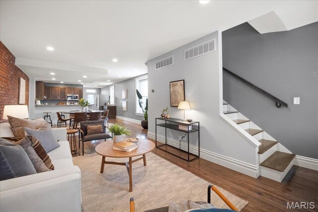3974 Utah St, Saint Louis, MO 63116 - living area featuring wood finished floors, recessed lighting, baseboards, and stairway
