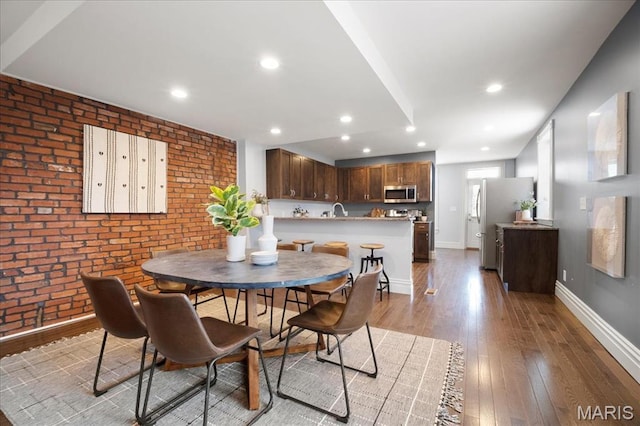 3974 Utah St, Saint Louis, MO 63116 - dining space with brick wall, light wood-style floors, baseboards, and recessed lighting