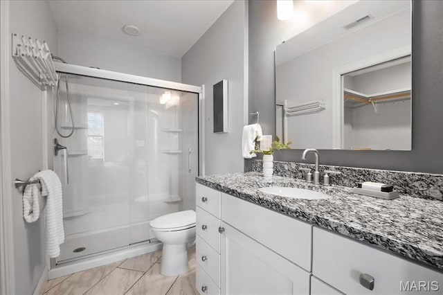 3974 Utah St, Saint Louis, MO 63116 - bathroom featuring a shower stall, toilet, vanity, and marble look tile flooring