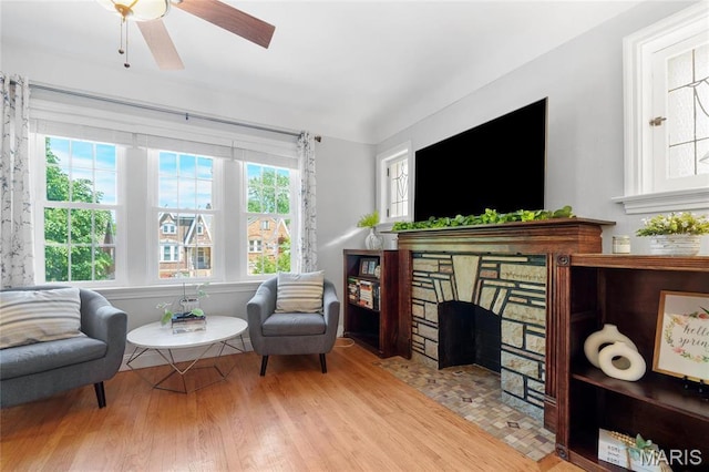 living area featuring wood finished floors and ceiling fan