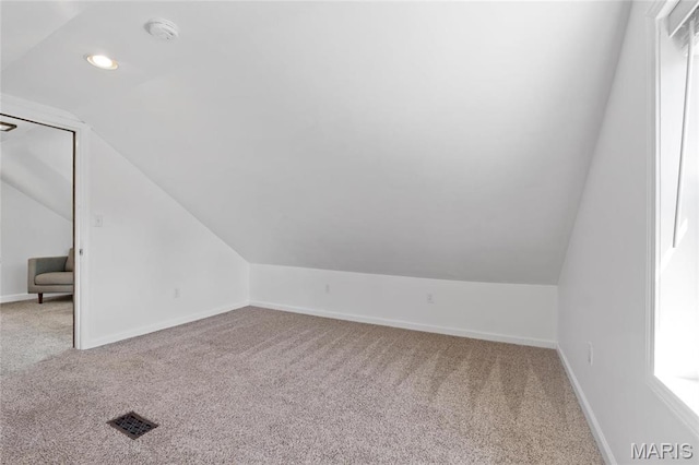 additional living space featuring carpet floors, vaulted ceiling, baseboards, and recessed lighting