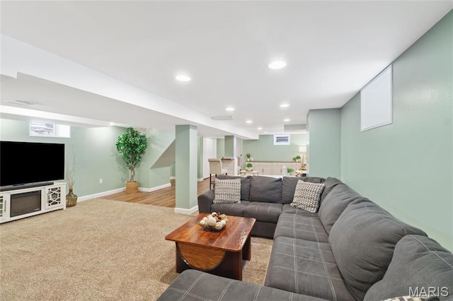 carpeted living area featuring bar, recessed lighting, and baseboards