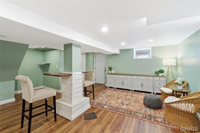 bar featuring wood finished floors, baseboards, and recessed lighting