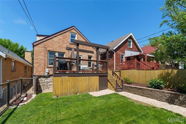rear view of house with brick siding and a deck