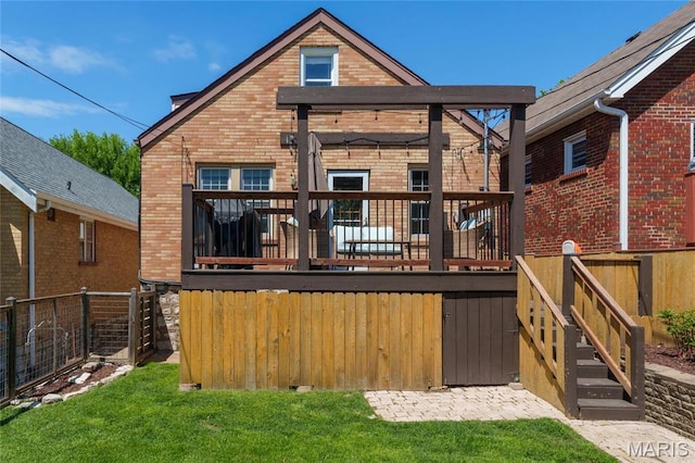 rear view of property featuring brick siding, a wooden deck, and stairway