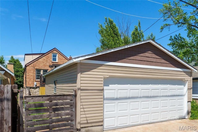 detached garage featuring fence