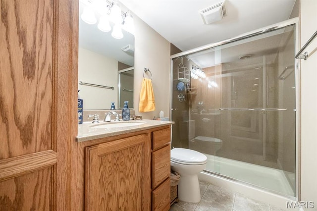 full bathroom with a stall shower, tile patterned flooring, vanity, and toilet