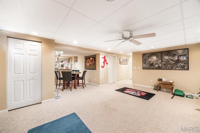 rec room with carpet, a drop ceiling, a ceiling fan, baseboards, and recessed lighting