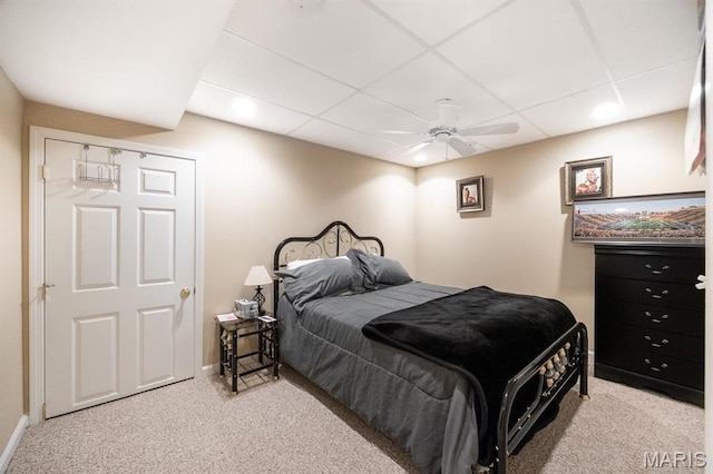 bedroom with carpet, ceiling fan, baseboards, recessed lighting, and a paneled ceiling