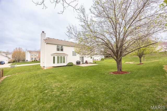 view of green lawn featuring a patio