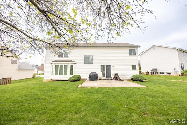 rear view of property with a patio area and a lawn