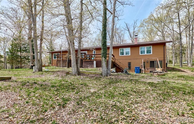 26168 Ridgetrail Dr, Warrenton, MO 63383 - rear view of house with a wooden deck, stairs, and a chimney