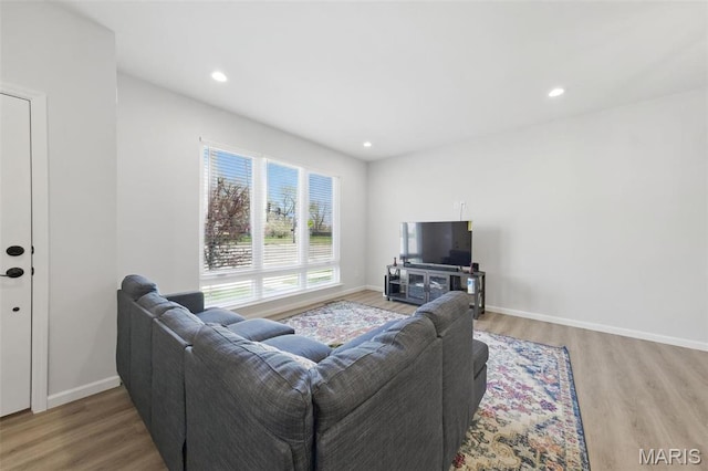 living room featuring wood finished floors, baseboards, and recessed lighting