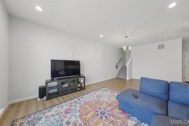 living room with wood finished floors, stairway, baseboards, and recessed lighting