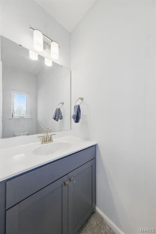 bathroom with vanity and baseboards