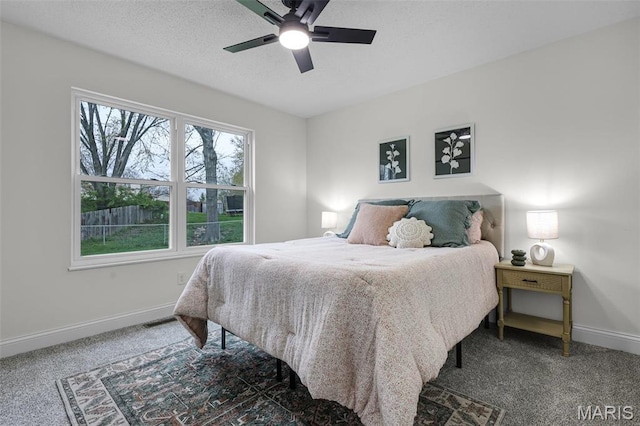 bedroom with carpet, baseboards, ceiling fan, and a textured ceiling