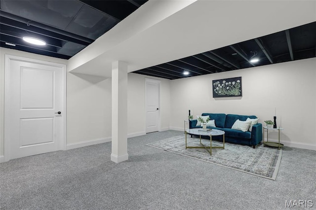 carpeted living area featuring baseboards