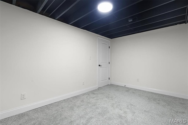 carpeted spare room with baseboards