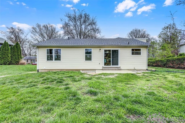 rear view of house with a lawn and a patio