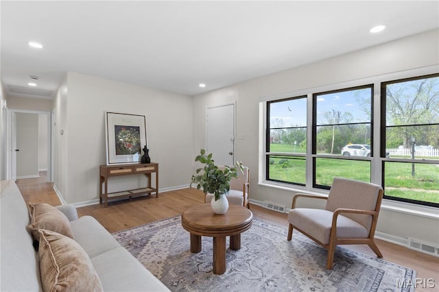 4410 Robbins Mill Rd, Florissant, MO 63034 - living room featuring light wood-style flooring, baseboards, and recessed lighting
