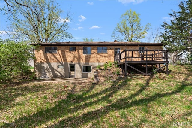 4410 Robbins Mill Rd, Florissant, MO 63034 - rear view of property featuring a wooden deck, a lawn, and brick siding