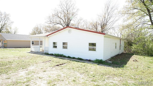 view of side of home featuring a lawn