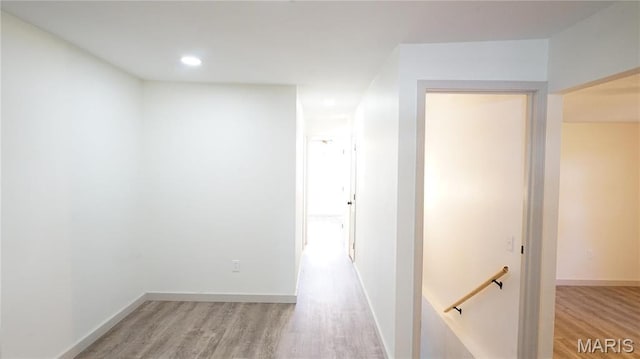 corridor with an upstairs landing, light wood-style flooring, recessed lighting, and baseboards