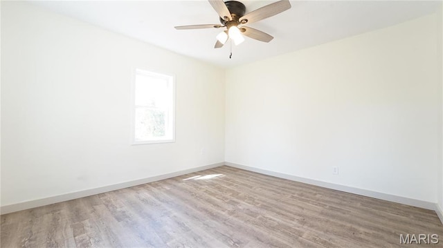unfurnished room with wood finished floors, baseboards, and a ceiling fan
