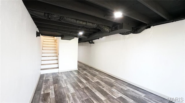 finished basement with wood finished floors and stairway