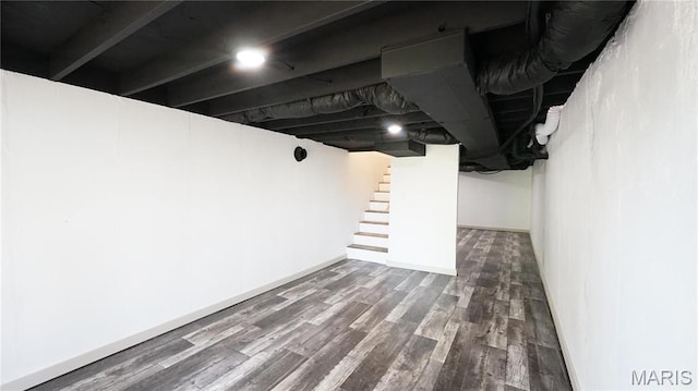 finished below grade area with wood finished floors, stairs, and baseboards