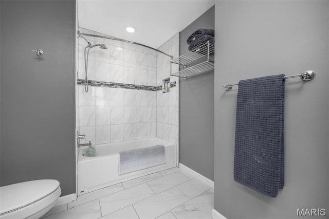 full bath featuring baseboards, marble look tiles, toilet, shower / washtub combination, and recessed lighting