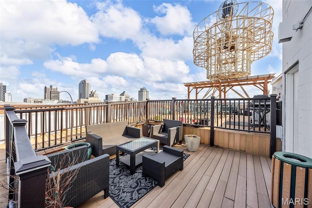 deck featuring a pergola, outdoor lounge area, and a city view