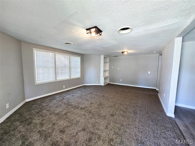 828 W Elk St, Dexter, MO 63841 - empty room with dark colored carpet, baseboards, and a textured ceiling