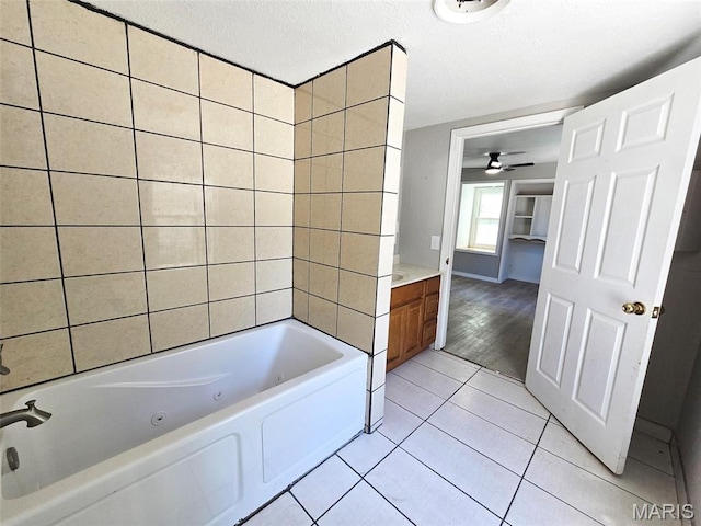 828 W Elk St, Dexter, MO 63841 - bathroom with tile patterned floors, vanity, ceiling fan, a textured ceiling, and baseboards