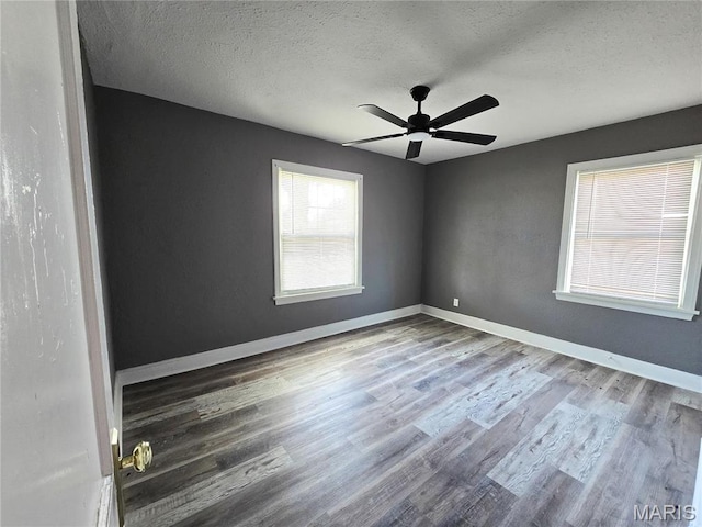 unfurnished room featuring wood finished floors, a textured ceiling, ceiling fan, and baseboards