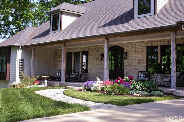 3 Inland Ct, Wright City, MO 63390 - doorway to property featuring covered porch, roof with shingles, and brick siding