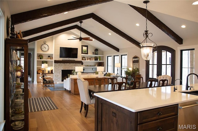 3 Inland Ct, Wright City, MO 63390 - kitchen featuring wood finished floors, dark brown cabinetry, light countertops, decorative light fixtures, and ceiling fan