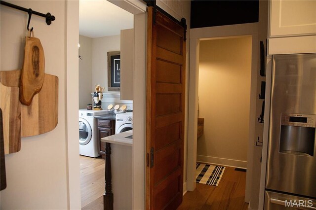 3 Inland Ct, Wright City, MO 63390 - laundry area featuring washing machine and dryer, a barn door, and light wood finished floors