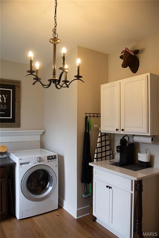 3 Inland Ct, Wright City, MO 63390 - laundry room with washer / dryer, cabinet space, wood finished floors, and baseboards