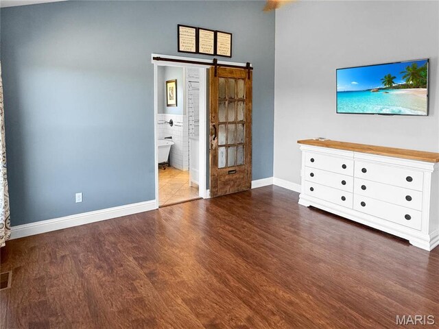 641 Ponderosa Trl, Beaufort, MO 63013 - unfurnished living room featuring wood finished floors, a barn door, and baseboards