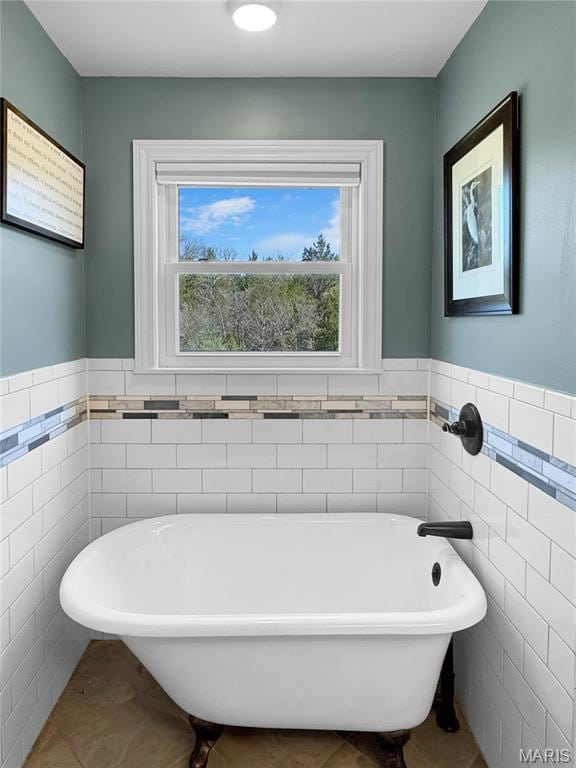 641 Ponderosa Trl, Beaufort, MO 63013 - full bath with tile walls, tile patterned floors, a freestanding bath, and a wainscoted wall