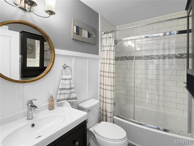 641 Ponderosa Trl, Beaufort, MO 63013 - bathroom featuring shower / bath combo with shower curtain, toilet, vanity, a decorative wall, and wainscoting