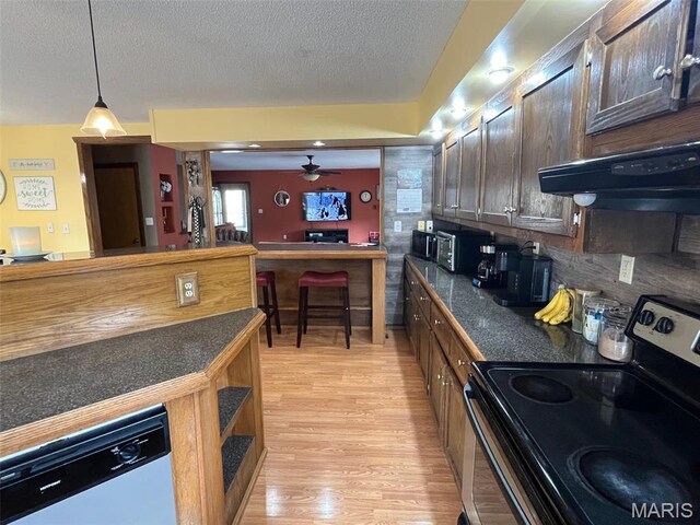 10303 Woodberry Rd, Potosi, MO 63664 - kitchen with stainless steel electric range, dark countertops, light wood-type flooring, dishwasher, and range hood