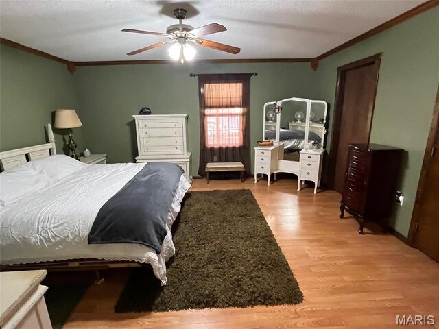 10303 Woodberry Rd, Potosi, MO 63664 - bedroom featuring ornamental molding, light wood-style floors, and a ceiling fan
