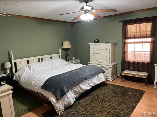 10303 Woodberry Rd, Potosi, MO 63664 - bedroom featuring light wood-type flooring, ornamental molding, a textured ceiling, and ceiling fan