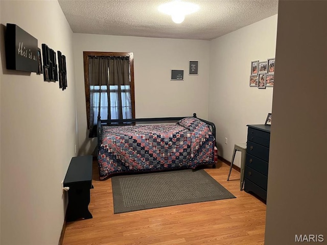10303 Woodberry Rd, Potosi, MO 63664 - bedroom with a textured ceiling and wood finished floors