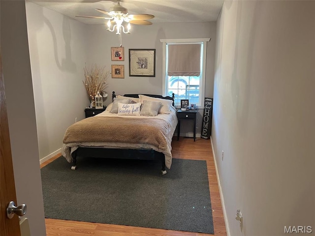 10303 Woodberry Rd, Potosi, MO 63664 - bedroom featuring wood finished floors, ceiling fan, and baseboards