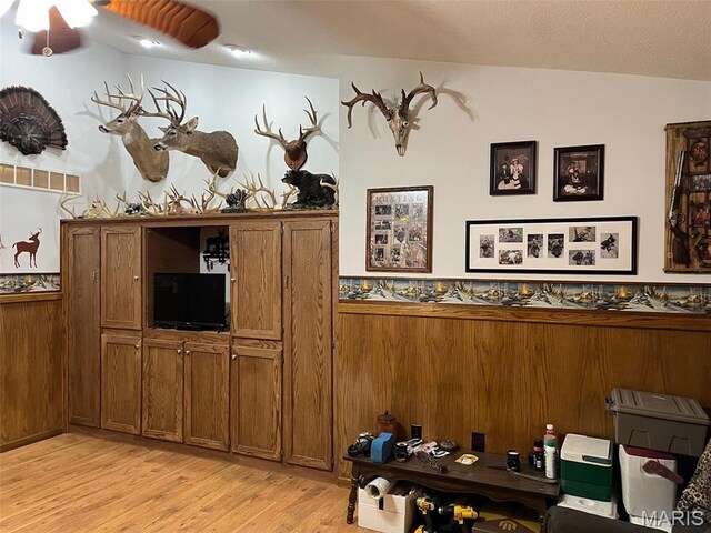 10303 Woodberry Rd, Potosi, MO 63664 - dining room featuring light wood-style flooring, wainscoting, ceiling fan, and wooden walls