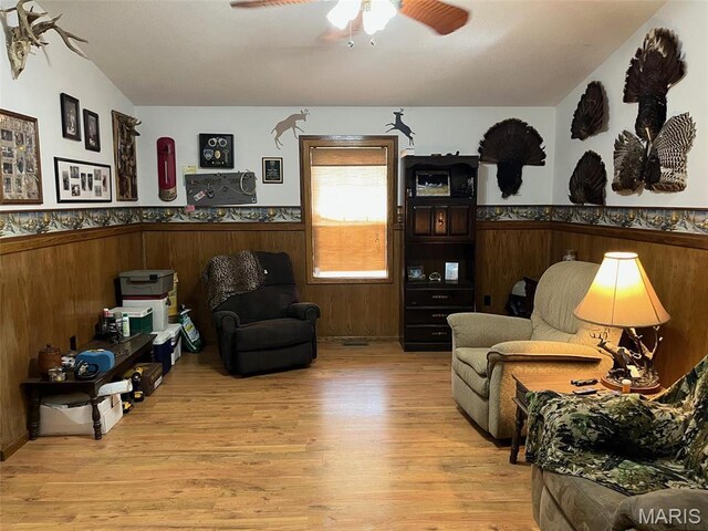 10303 Woodberry Rd, Potosi, MO 63664 - living area with wainscoting, wood finished floors, ceiling fan, and wood walls
