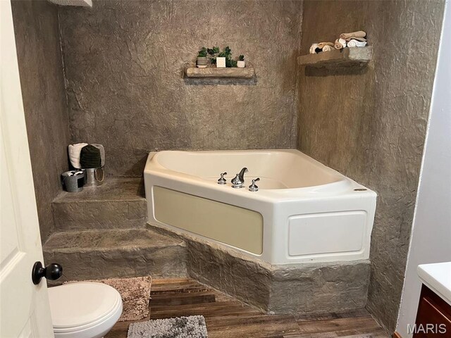 10303 Woodberry Rd, Potosi, MO 63664 - full bath with a bath, wood finished floors, toilet, and vanity